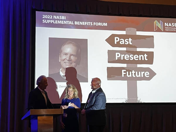 At the 2022 NASBI  Forum, Dan Pisetsky presents check to benefit the Heart Wiahes Fund.